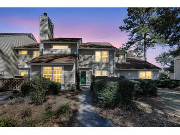 Charming two-story home with lush landscaping and inviting walkway to the front door at 1042 Planters Pl, Mount Pleasant, SC 29464
