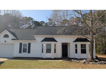 Charming single-story home with white siding, black shutters, and lush front yard landscaping at 107 Ranworth Ln, Summerville, SC 29485