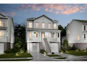 Charming two-story home featuring double garages, covered porch, and manicured landscaping at 2280 Minfarm Way # 529, Mount Pleasant, SC 29466