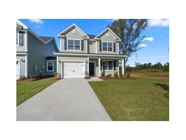 Charming two-story home with a well-manicured lawn and attached garage at 320 Abercom Place Dr, Moncks Corner, SC 29461
