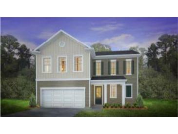 Inviting two-story home featuring a two-car garage and charming curb appeal at 336 Dickerson Ln, Lincolnville, SC 29485