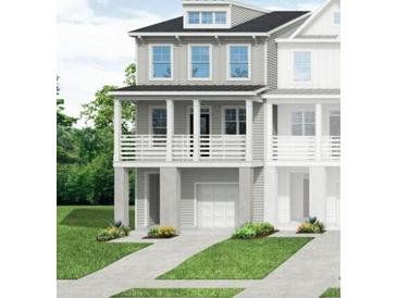 Charming home with covered porch, multiple windows, and an attached garage in a well-maintained community at 406 Katies Scenic Ct, Charleston, SC 29492