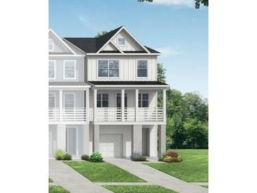 Charming two-story home with white siding, a porch and lush greenery at 416 Katies Scenic Ct, Charleston, SC 29492
