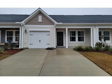 Charming one-story home with a single-car garage and a well-manicured front yard on a sunny day at 818 Descartes St, Summerville, SC 29486