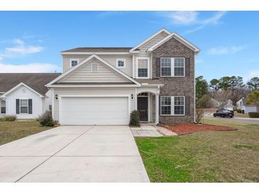 Charming two-story home with a brick and siding facade, well-manicured lawn, and a two-car attached garage at 9000 Hema Ln, Summerville, SC 29483