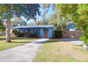 Charming single-story home with light blue painted exterior and a well-manicured front lawn at 1117 Oceanview Rd, Charleston, SC 29412