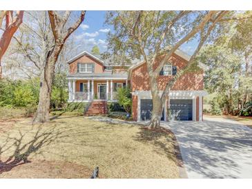 Charming two-story brick home with a welcoming front porch and a two-car garage at 1540 Strathmore Ln, Mount Pleasant, SC 29464