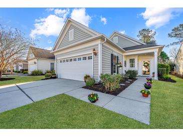 Charming single-Gathering home features a two-car garage, manicured landscaping, and a welcoming front porch at 157 Sea Lavender Ln, Summerville, SC 29486