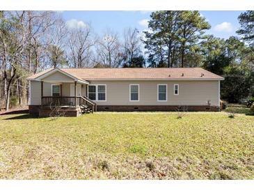 Charming single-story home with a welcoming front porch and well-maintained lawn at 1816 Grimball Rd, Charleston, SC 29412