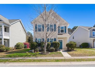 Charming two-story home with blue shutters and a manicured lawn at 1818 Towne St, Johns Island, SC 29455