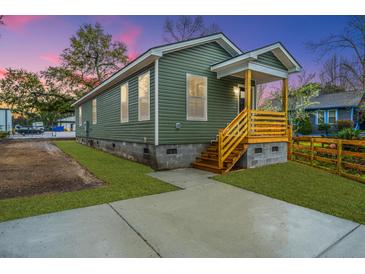 Charming home with a cozy front porch and newly landscaped yard at 2647 Tillman St, North Charleston, SC 29405