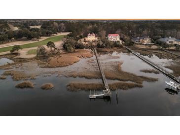 Panoramic aerial view of waterfront homes with private docks on a scenic waterway at twilight at 3232 Pignatelli Cres, Mount Pleasant, SC 29466