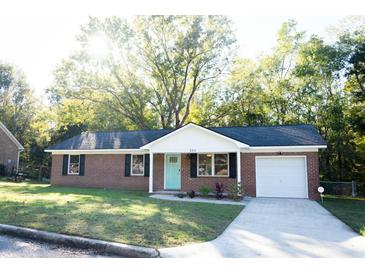 Charming one-story brick home with a well-manicured lawn and inviting curb appeal at 380 Furman Ln, Ladson, SC 29456