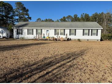 Charming single-story home featuring black shutters and a welcoming front porch at 60 Caboose Ct, Cottageville, SC 29435