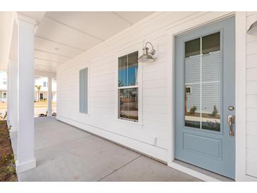 Charming front porch with a light blue door and white siding, offering a welcoming entrance to the home at 796 Clay Field Trl, Summerville, SC 29485