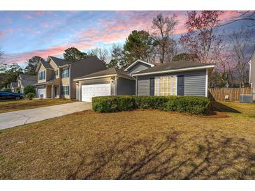 Charming home with a well-manicured lawn, garage, and beautiful sunset backdrop at 140 Moon Shadow Ln, Summerville, SC 29485