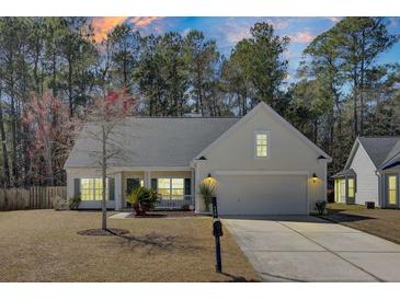 Charming single-story home with well-maintained lawn, two-car garage and inviting curb appeal at 1473 Coopers Hawk Dr, Hanahan, SC 29410