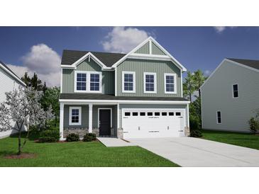 Charming two-story home featuring a spacious two-car garage and beautifully landscaped front yard at 326 Casein St, Summerville, SC 29483