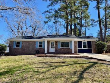 Charming brick ranch home with a well-maintained lawn and inviting curb appeal at 377 Furman Ln, Ladson, SC 29456