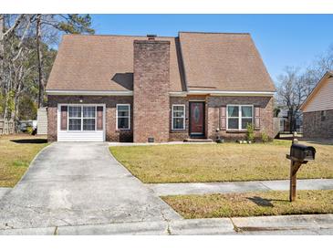 Charming brick home featuring a well-maintained lawn and a classic architectural design at 404 Terrier Rd, Goose Creek, SC 29445