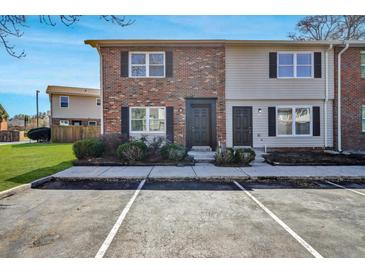 Charming townhome featuring a brick facade, black shutters, and convenient parking at 415 Parkdale Dr # 12 A, Charleston, SC 29414