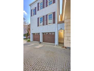 Charming three-story home with a two-car garage and cobblestone driveway at 4341 Cordial Aly, North Charleston, SC 29405