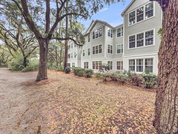 Multi-story home with well-maintained landscaping and mature trees providing shade at 60 Fenwick Hall Allee # 314, Johns Island, SC 29455