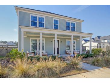 Charming two-story home with a welcoming front porch and well-manicured landscaping at 643 Blueway Ave, Summerville, SC 29486