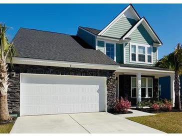 Charming two-story home featuring a two-car garage, stone accents, and a manicured lawn at 804 S Pointe Blvd, Summerville, SC 29483