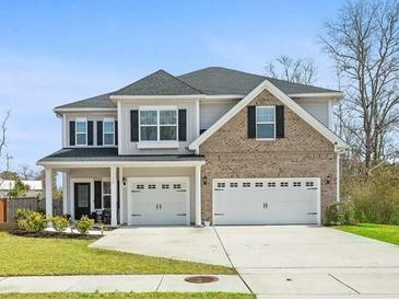Charming two-story home with a well-manicured lawn and a two-car garage at 1114 Donerail Ln, Johns Island, SC 29455