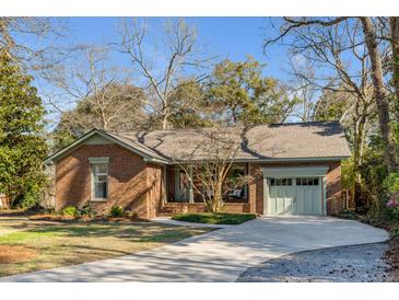 Charming brick home with a well-manicured lawn, a paved driveway, and inviting curb appeal at 1228 Penny Cir, Mount Pleasant, SC 29464