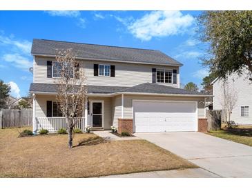 Charming two-story home featuring a two-car garage and a well-maintained front yard at 2508 Melville Rd, North Charleston, SC 29406