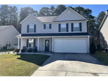 Charming two-story home with attached two-car garage, well-maintained lawn, and classic curb appeal at 415 Aberdeen Cir, Summerville, SC 29483