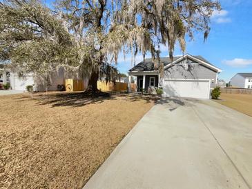 Charming single-Gathering home with a two-car garage and a traditional design on a large lot with a mature tree at 431 Eva St, Moncks Corner, SC 29461
