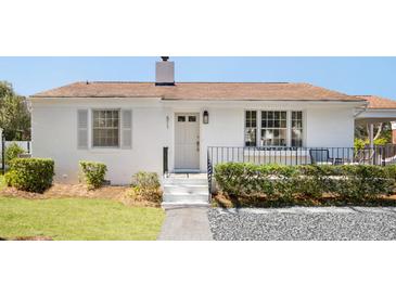 Charming one-story home featuring a white brick exterior, manicured lawn and walkway leading to the front door at 511 Sarah St, Charleston, SC 29407