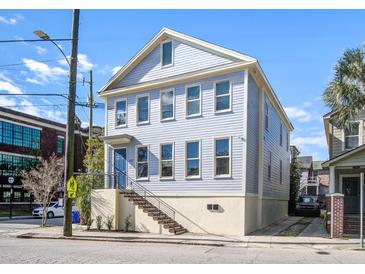 Charming two-story home with light blue siding, lots of windows and stairs to the front door at 757 King St, Charleston, SC 29403