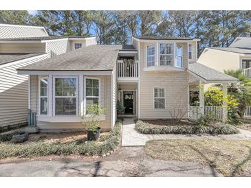 Charming home with a well-maintained yard and a small balcony above the doorway at 8 Townpark Ln # B, Charleston, SC 29412