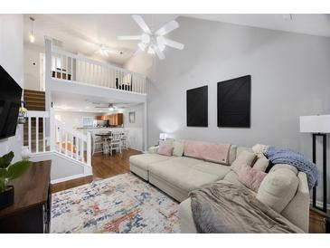 Bright living room with high ceilings, open floor plan and cozy sectional sofa at 8618 Grassy Oak Trl, North Charleston, SC 29420