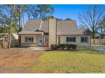 Charming single-Gathering home with a well-maintained lawn and inviting entrance at 100 Traders Station Rd, Summerville, SC 29486
