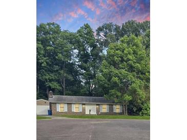 Charming one-story home nestled among tall trees with a brick facade and inviting front entrance at 106 Shirley Dr, Ladson, SC 29456