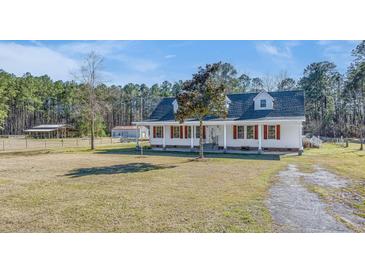 Beautiful home with red shutters, mature trees, and a spacious yard for outdoor activities at 1677 French Santee Rd, Jamestown, SC 29453