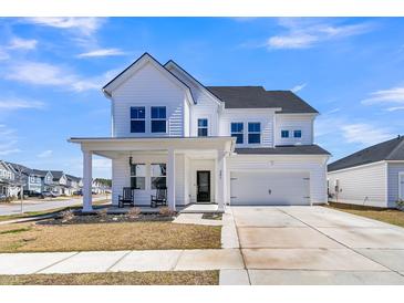 Charming two-story home with white siding, a covered front porch, and a two-car garage at 201 Garden Lily Lane, Summerville, SC 29485