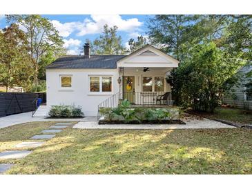 Charming bungalow featuring a landscaped front yard, a cozy front porch, and a freshly painted exterior at 2115 Wappoo Dr, Charleston, SC 29412