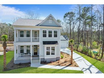 Charming two-story home with double porches, beautiful landscaping, and a detached garage at 4217 Royal Harbor Rd, Hollywood, SC 29449