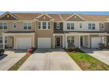 Charming townhome with two-car garage, neutral siding, manicured lawn, and concrete driveway at 509 Nadir Ct, Summerville, SC 29486