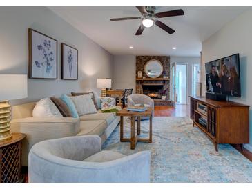 Inviting living room features a brick fireplace, ceiling fan, and comfortable seating, perfect for relaxation at 960 Mooring Dr, Charleston, SC 29412