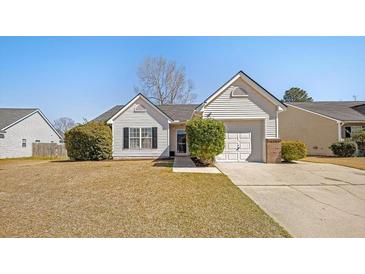 Charming single-story home with white siding, attached garage, and well-manicured front yard at 103 Old Tree Rd, Goose Creek, SC 29445