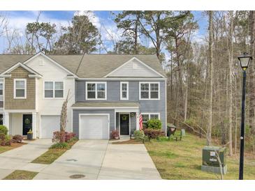 Charming two-story home with a one-car garage and well-manicured landscaping at 127 Rosefield Ct, Summerville, SC 29485