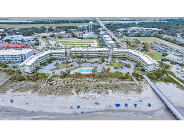 Breathtaking aerial view of beachside condos and pool, offering stunning coastal living and resort-style amenities at 1300 Ocean Blvd # 114 A, Isle of Palms, SC 29451