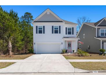 Charming two-story home with a well-manicured lawn and a delightful pink front door at 162 Cherry Grv Dr, Summerville, SC 29483